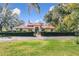 House exterior with red tile roof, fountain, and iron gate at 1130 Elysium Blvd, Mount Dora, FL 32757