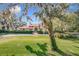 One-story home with red tile roof and lush landscaping at 1130 Elysium Blvd, Mount Dora, FL 32757