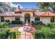 Home exterior showcasing a red tile roof, arched entryway, and fountain at 1130 Elysium Blvd, Mount Dora, FL 32757