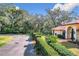 House exterior with lush landscaping and a curved driveway at 1130 Elysium Blvd, Mount Dora, FL 32757