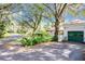 House exterior with green garage door and driveway at 1130 Elysium Blvd, Mount Dora, FL 32757