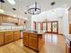 Bright kitchen with island, wood cabinets, and tile countertops at 1130 Elysium Blvd, Mount Dora, FL 32757