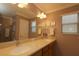 Elegant bathroom with dual sinks, large mirror, and ample counter space at 1189 Homeland Park St, The Villages, FL 32162