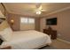 Bright bedroom with a queen-size bed and plantation shutters at 1189 Homeland Park St, The Villages, FL 32162