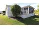 Back exterior view with landscaping and raised patio at 1189 Homeland Park St, The Villages, FL 32162