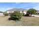 One-story home with shutters, palm trees, and manicured lawn at 1189 Homeland Park St, The Villages, FL 32162