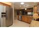 Stainless steel refrigerator in a kitchen with wood cabinets at 1189 Homeland Park St, The Villages, FL 32162