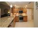 Kitchen with granite countertops and wood cabinets at 1189 Homeland Park St, The Villages, FL 32162