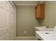 Laundry room with built-in cabinets and a utility sink at 1189 Homeland Park St, The Villages, FL 32162