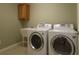 Laundry room with washer, dryer, sink, and additional storage at 1189 Homeland Park St, The Villages, FL 32162