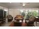 Relaxing sunroom with wicker furniture and sliding glass doors at 1189 Homeland Park St, The Villages, FL 32162