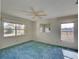 Large bedroom with two windows and blue carpet at 1199 Cr 542G, Bushnell, FL 33513