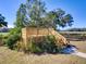 Elevated wooden deck with stairs and landscaping at 1199 Cr 542G, Bushnell, FL 33513