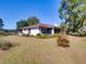 White house with brown roof and screened porch at 1199 Cr 542G, Bushnell, FL 33513