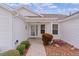 Front entry with walkway, landscaping, and a white exterior at 1216 Addison Ave, The Villages, FL 32162