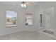 Bright entryway with tile floors, two windows, and a view of the bathroom at 1216 Addison Ave, The Villages, FL 32162