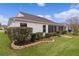 Rear view of house showing landscaping and screened porch at 1216 Addison Ave, The Villages, FL 32162