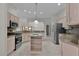 Bright kitchen with stainless steel appliances and an island at 1216 Addison Ave, The Villages, FL 32162