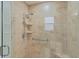 Walk-in shower with tiled walls and seat at 1216 Addison Ave, The Villages, FL 32162