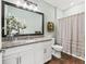 Spa-like bathroom with granite vanity and striped shower curtain at 12213 Se 176Th Loop, Summerfield, FL 34491