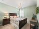 Elegant bedroom with dark wood furniture and a chandelier at 12213 Se 176Th Loop, Summerfield, FL 34491