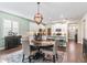 Dining room with round table, chandelier, and hardwood floors at 12213 Se 176Th Loop, Summerfield, FL 34491