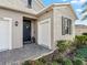 Front entryway with dark-colored door and white garage door at 12213 Se 176Th Loop, Summerfield, FL 34491