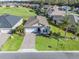 Charming single-story home with a manicured lawn, paved driveway, and attached garage at 12213 Se 176Th Loop, Summerfield, FL 34491