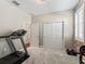 Bright home gym with treadmill, weights, and ample storage at 12213 Se 176Th Loop, Summerfield, FL 34491