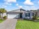 Attractive curb appeal with a two-car garage and landscaped yard at 12213 Se 176Th Loop, Summerfield, FL 34491