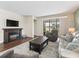 Light and airy living room featuring a fireplace and sliding glass doors at 12213 Se 176Th Loop, Summerfield, FL 34491