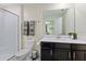 Bathroom featuring a shower, toilet, and a vanity with a sink and black cabinets at 1257 Challenge Dr, Davenport, FL 33896