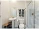 Bright bathroom featuring a pedestal sink, gray towels, and glass-enclosed shower at 1257 Challenge Dr, Davenport, FL 33896