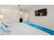 Comfortable bedroom showing a large television, double closet, and full ensuite bathroom at 1257 Challenge Dr, Davenport, FL 33896