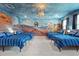 The themed bedroom features custom mural and multiple beds, a unique and fun space at 1257 Challenge Dr, Davenport, FL 33896