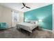 King bedroom with teal accent wall and ceiling fan at 1257 Challenge Dr, Davenport, FL 33896