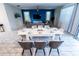 Open dining area features a modern white table and decor with views into the living room at 1257 Challenge Dr, Davenport, FL 33896
