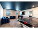 Spacious game room with an air hockey table, foosball table, seating, and a TV at 1257 Challenge Dr, Davenport, FL 33896