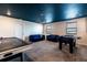 A wide shot of game room features an air hockey table, a foosball table and sofas at 1257 Challenge Dr, Davenport, FL 33896