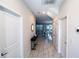 Bright hallway featuring marble-like floors and decorative furnishings leading to a dining area at 1257 Challenge Dr, Davenport, FL 33896