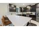 Modern kitchen with dark cabinetry, white countertops, and breakfast bar at 1257 Challenge Dr, Davenport, FL 33896