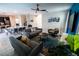 An open-concept living room provides comfortable seating and an airy atmosphere with a view of the kitchen and dining area at 1257 Challenge Dr, Davenport, FL 33896