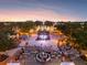 Aerial view of the community at sunset, featuring a town square at 1276 Bennett Pl, The Villages, FL 32162