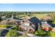 Aerial view of community clubhouse with landscaping and golf course at 1276 Bennett Pl, The Villages, FL 32162