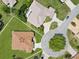 An aerial view shows the home's roof, lawn, and surrounding neighborhood cul-de-sac, offering a sense of community at 1276 Bennett Pl, The Villages, FL 32162