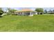 Large backyard with lush grass and a view of the house at 1276 Bennett Pl, The Villages, FL 32162