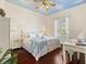 Bright bedroom with hardwood flooring, a ceiling fan and a blue sky ceiling mural at 1276 Bennett Pl, The Villages, FL 32162