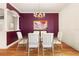 Elegant dining room with a glass table and chandelier at 1276 Bennett Pl, The Villages, FL 32162