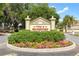 Community entrance with a landscaped median and signage at 1276 Bennett Pl, The Villages, FL 32162