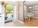 Inviting foyer with a view of the dining area, featuring a welcome mat and a glimpse of the outdoors at 1276 Bennett Pl, The Villages, FL 32162